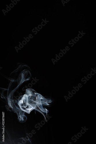 White or gray smoke isolated on dark background.