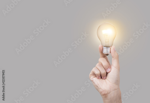 Business hand holding light bulb, concept of new ideas with new innovation and new creativity. photo