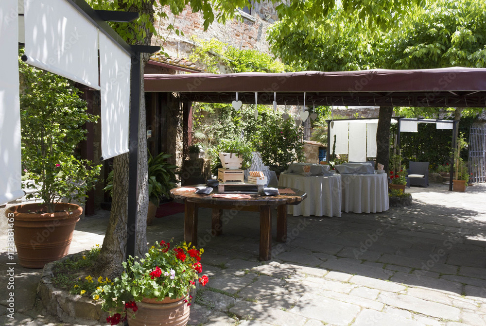 Set up of the outdoor part of a restaurant on Tuscan hills, for a wedding, nobody around
