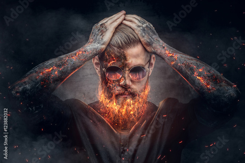 Fényképezés Demonic male with burning beard and arms.