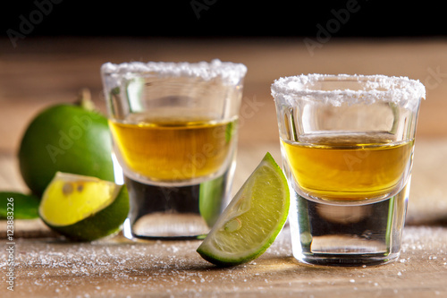 two tequila shots with lime slice and salt