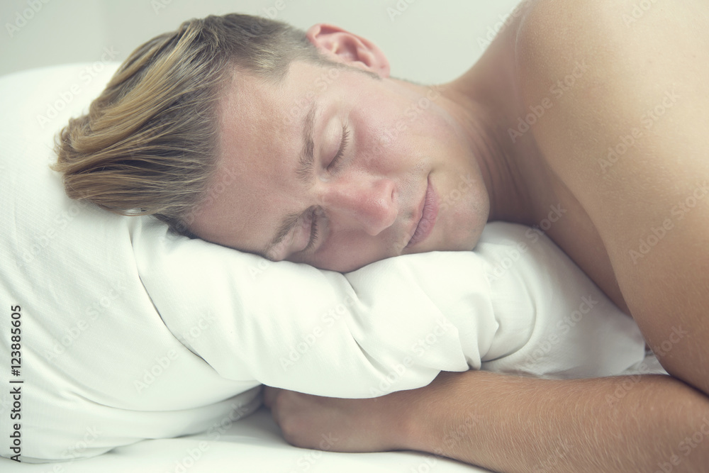 blond man lying in bed sleeping blond man lying in bed sleeping