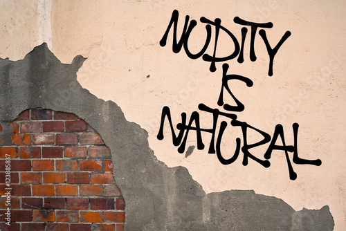 Nudity Is Natural - Handwritten graffiti sprayed on the wall - freedom to naturism, nudism and exposing naked body without clothes. Libertarian fight and protest against prudery