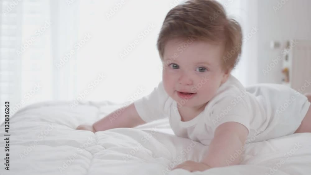 Cute happy baby cuddling on a soft blanket while lying on his tummy.
Cute happy baby cuddling on a soft blanket while lying on his tummy.