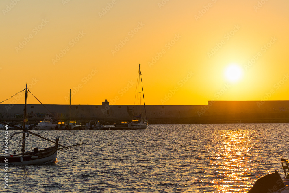 shining sun over Alghero harbor at dusk shining sun over Alghero harbor at dusk
