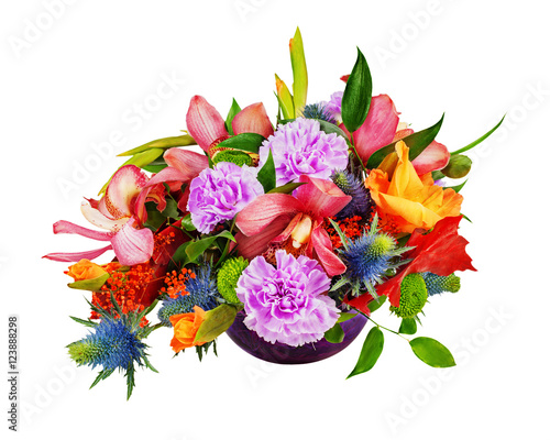 Floral bouquet of orchids, gladioluses and carnations arrangement centerpiece in blue glass vase isolated on white background