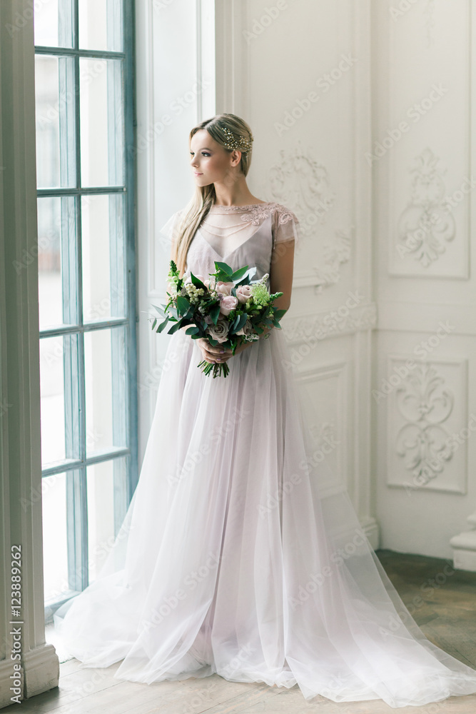 Young women with wedding dress in very bright room, some fine fi Young women with wedding dress in very bright room, some fine fi