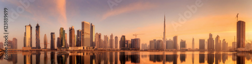 Valokuvatapetti Panoramic view of Business bay and downtown area of Dubai, reflection in a river