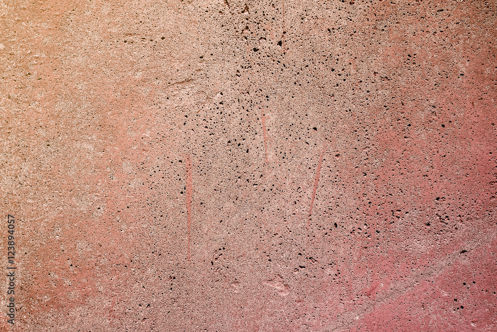 An old concrete wall painted in orange.