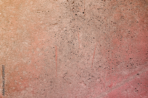 An old concrete wall painted in orange. © Roberto Sorin