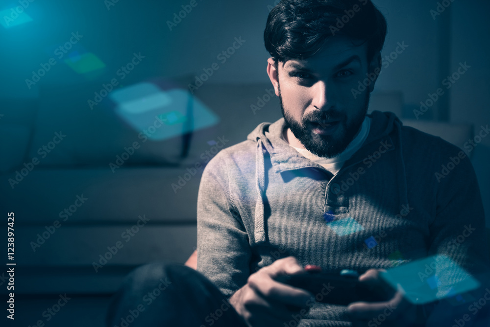 Enthusiastic man using playing console at home Enthusiastic man using playing console at home