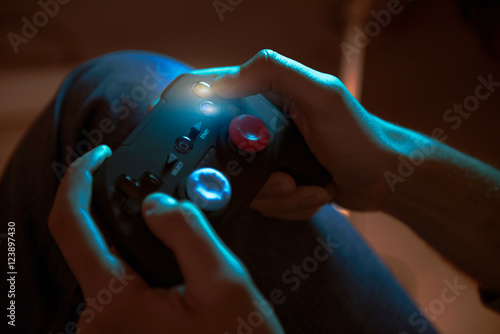 Young man holding playing console in his hands