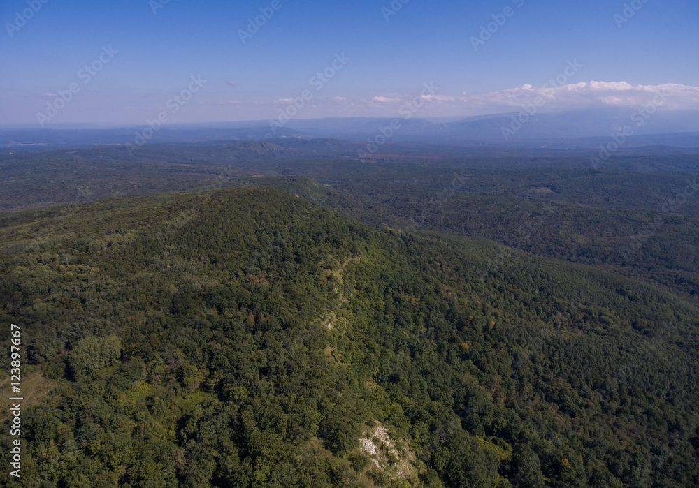Aerial panorama. Hills covered with forest