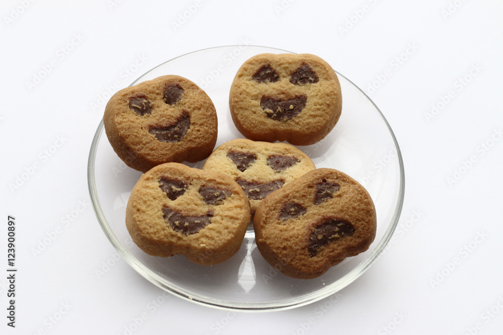 Halloween cookies in a transparent plate in a white background