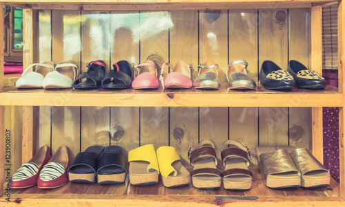 Women's shoes on shelves made of wood.