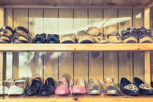 Women's shoes on shelves made of wood.