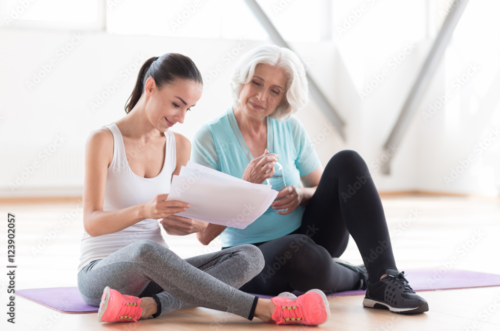 Serious concentrated women looking at the piece of paper Serious concentrated women looking at the piece of paper
