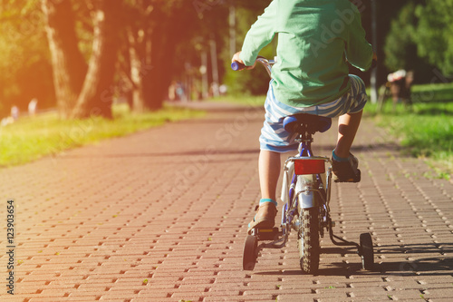 little boy riding bike outdoors