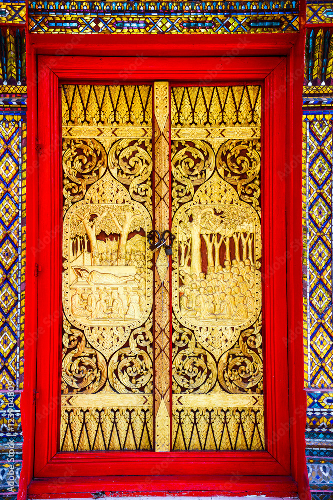 Buddhist church doors with Thai traditional art.