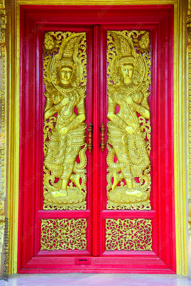 Buddhist church doors with Thai traditional art.