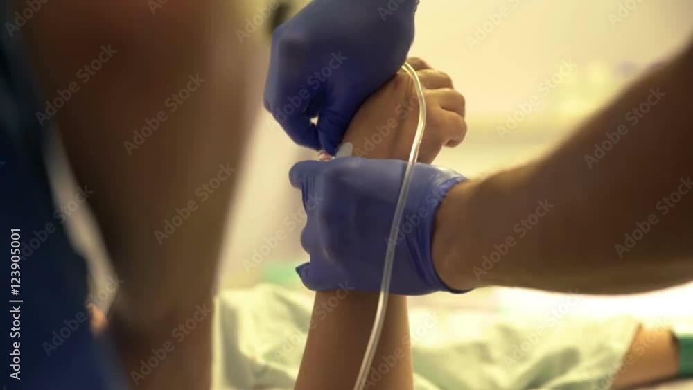 Before giving birth, a nurse is giving an injection into the woman's hand. Close-up shot.
Before giving birth, a nurse is giving an injection into the woman's hand. Close-up shot.