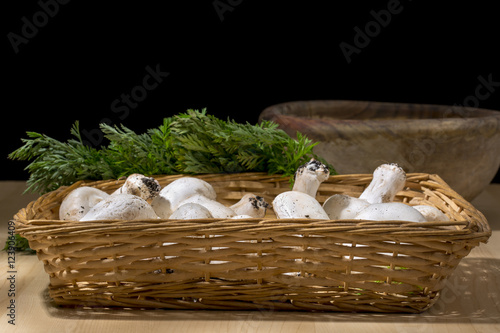Tableau sur toile Wicker basket with raw white mushrooms. Organic food