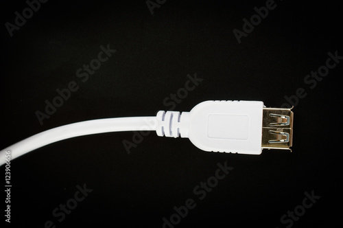 White usb cable. On the black fone.Top view. Flat lay.