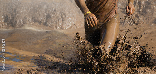 Man running in mud photo