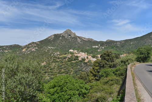 Green Corsican mountain with a small village Pigna