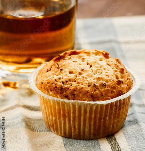 pastry, one muffin, a glass of apple juice on the table. Close-up photo