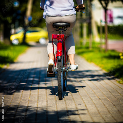 Fototapeta Naklejka Na Ścianę i Meble -  Urban biking - woman riding bike in city