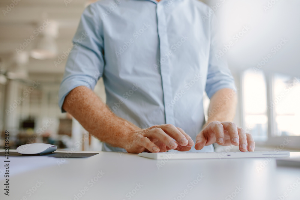 Businessman hands typing on computer keyboard Businessman hands typing on computer keyboard