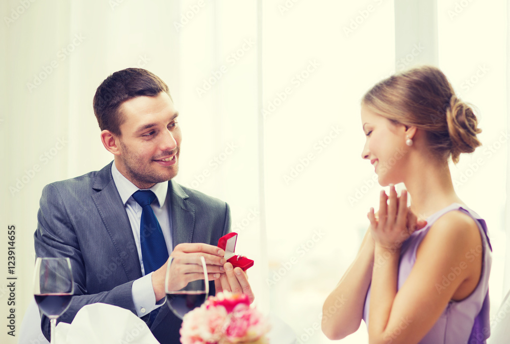 man proposing to his girlfriend at restaurant man proposing to his girlfriend at restaurant