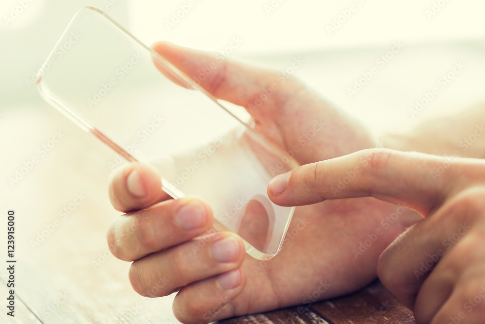 close up of male hand with transparent smartphone close up of male hand with transparent smartphone