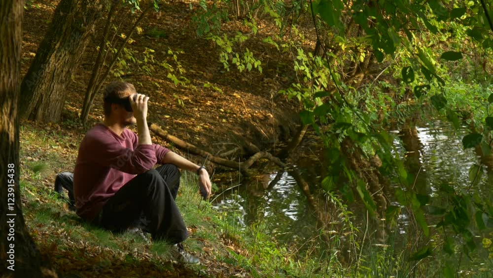 Man Puts on 360Vr Glasses Watching Video 360 Degrees Playing Virtual Games in Sunny Day Park by the Water Then Removes the Headset Looking at Water Man Puts on 360Vr Glasses Watching Video 360 Degrees Playing Virtual Games in Sunny Day Park by the Water Then Removes the Headset Looking at Water