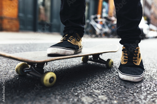 Young skateboarder on the street, partial view