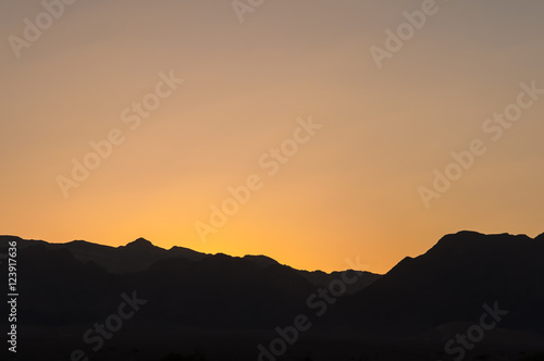 Sunset over mountain ridge in Negev desert, Israel with copy space for background design