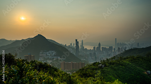 modern city next to mountain in sunset