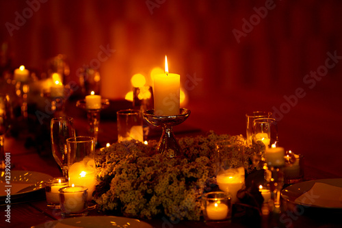 Red room illuminated with yellow candle light