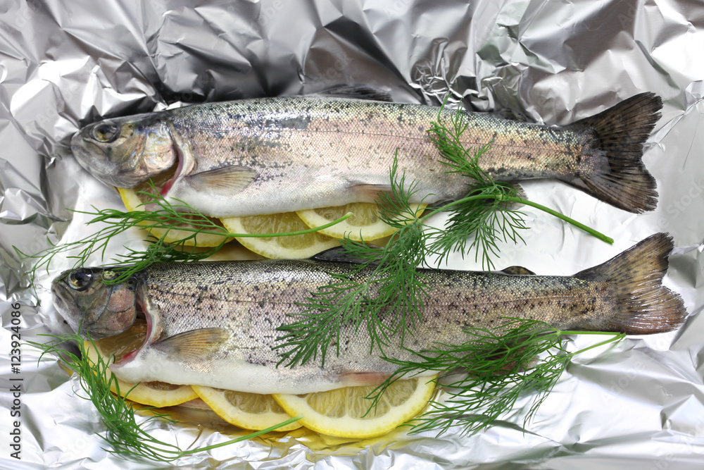 whole rainbow trout baked in foil (before oven baking). whole rainbow trout baked in foil (before oven baking).