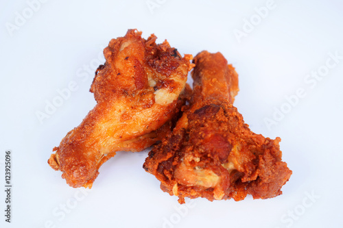 Two pieces of fried chicken is placed on a white background. /Selective focus.