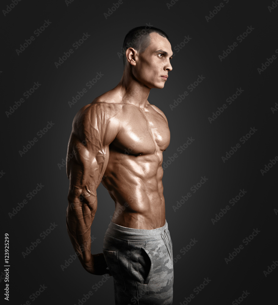 Fototapeta premium Strong Athletic Man Fitness Model Torso showing six pack abs.