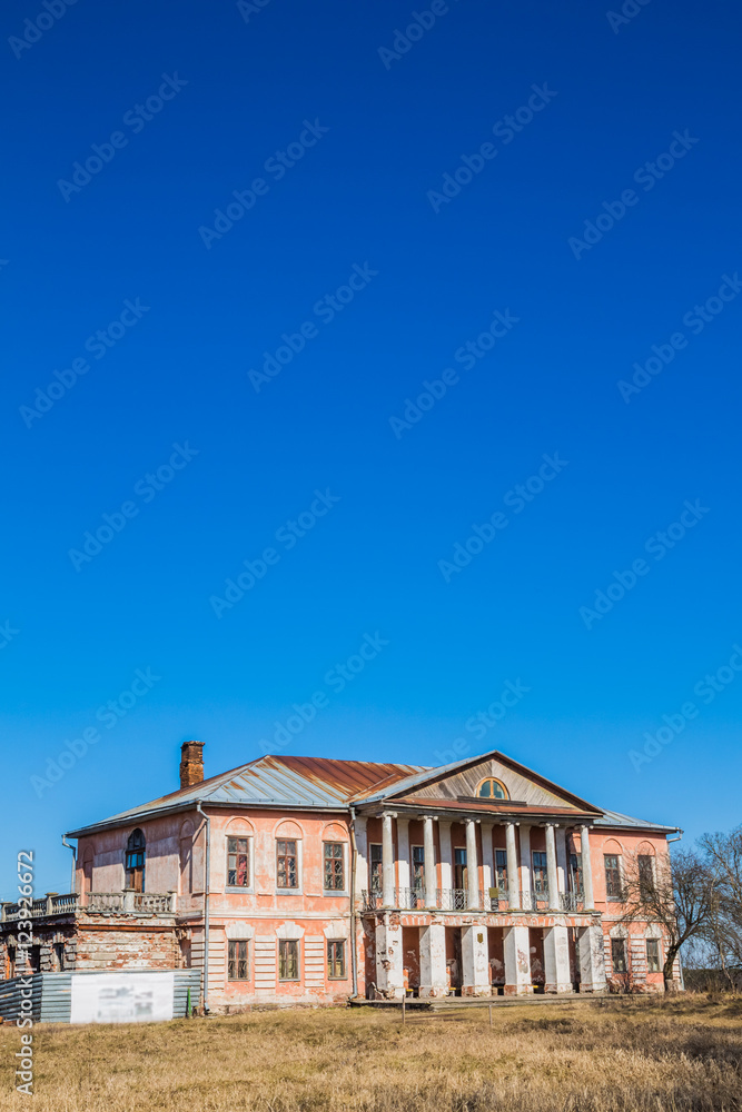 The building of manor on a background of bright blue sky
