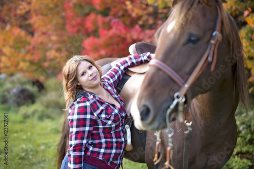Beautiful and natural adult woman outdoors with horse