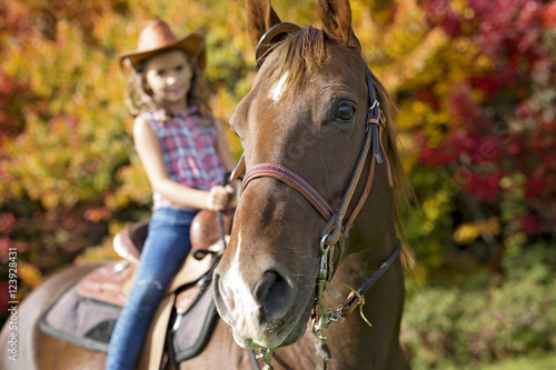 Autumn season young girl and horse