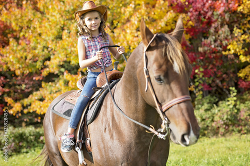 Autumn season young girl and horse