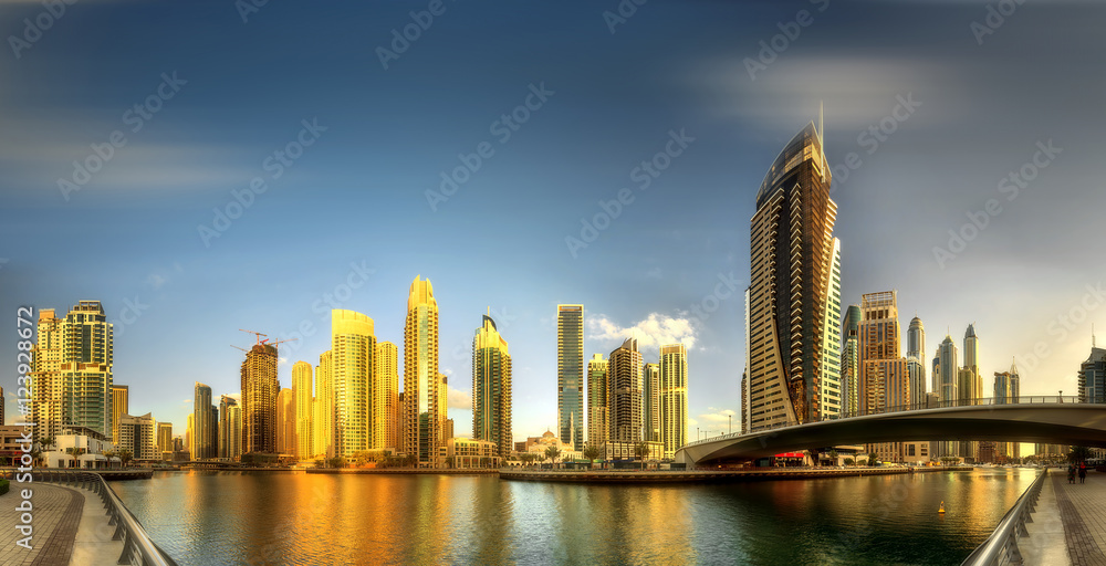 Panoramic view of Dubai Marina bay with yacht and cloudy sky, Dubai, UAE