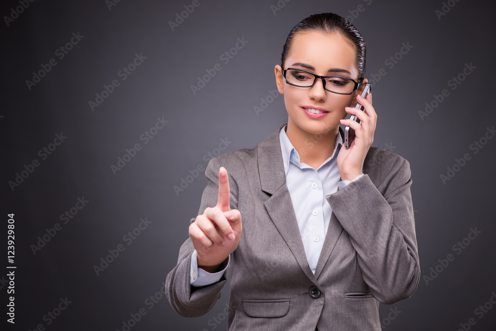 Businesswoman using mobile phone in business concept