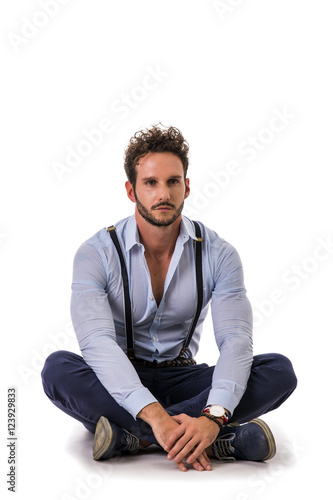 Handsome elegant young man with elegant shirt, suspenders, isolated on white, smiling and looking at camera