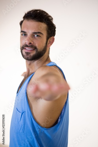 Portrait of man performing stretching exercise